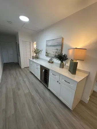 a bathroom with a double vanity sink toilet and a tub