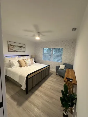 a bedroom with a bed and a window