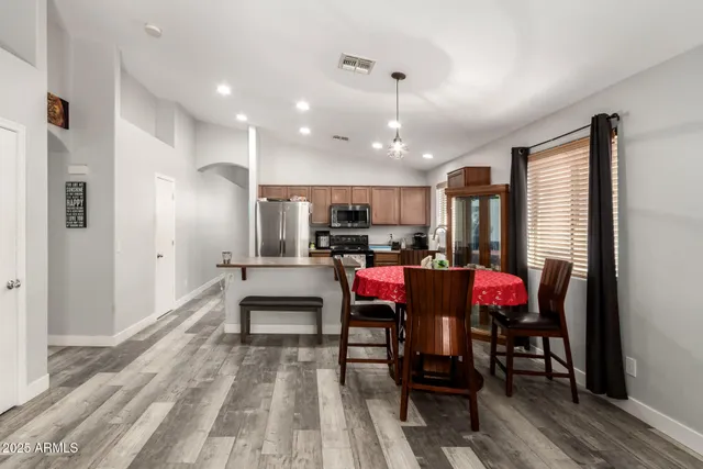 a view of a dining room with furniture and a rug