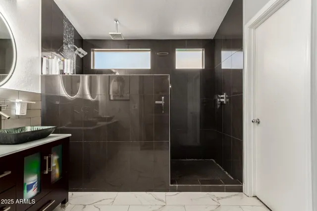 a bathroom with a glass shower door