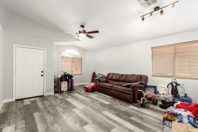 a living room with furniture a window and gym equipment