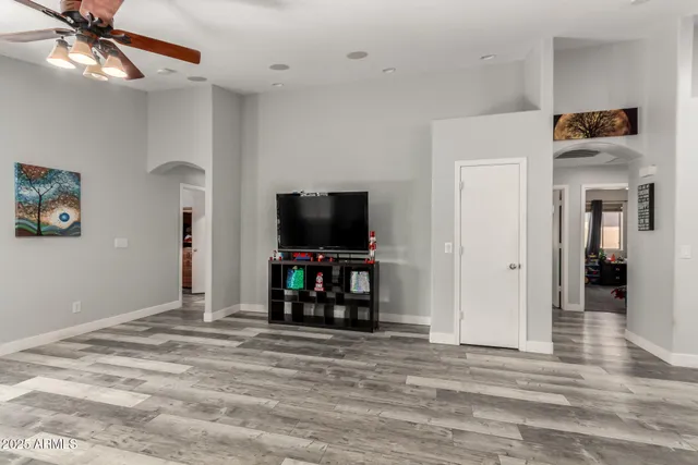a view of a livingroom with wooden floor and a flat screen tv