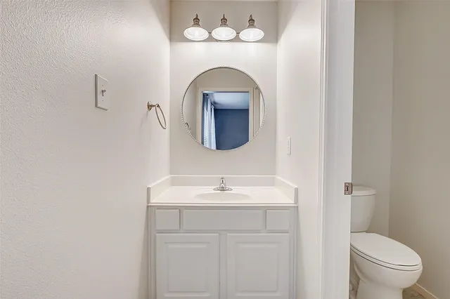an empty room with windows and ceiling fan view