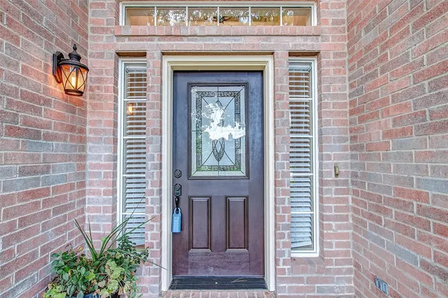 a view of a hallway with wooden floor and a window