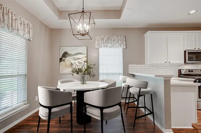 a view of empty room with kitchen and window
