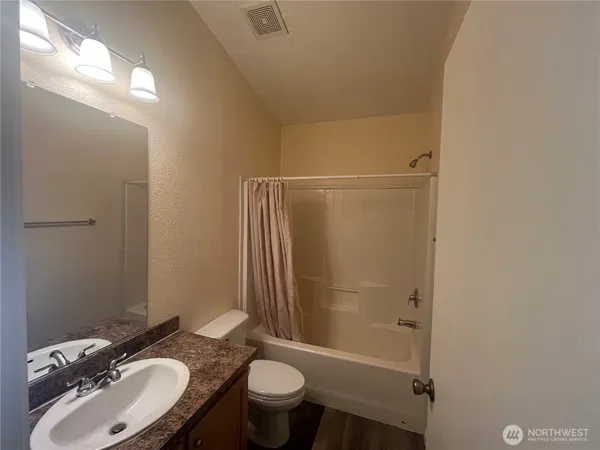a view of a kitchen with a sink and a refrigerator