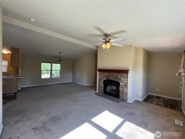 a view of a livingroom with a fireplace and window