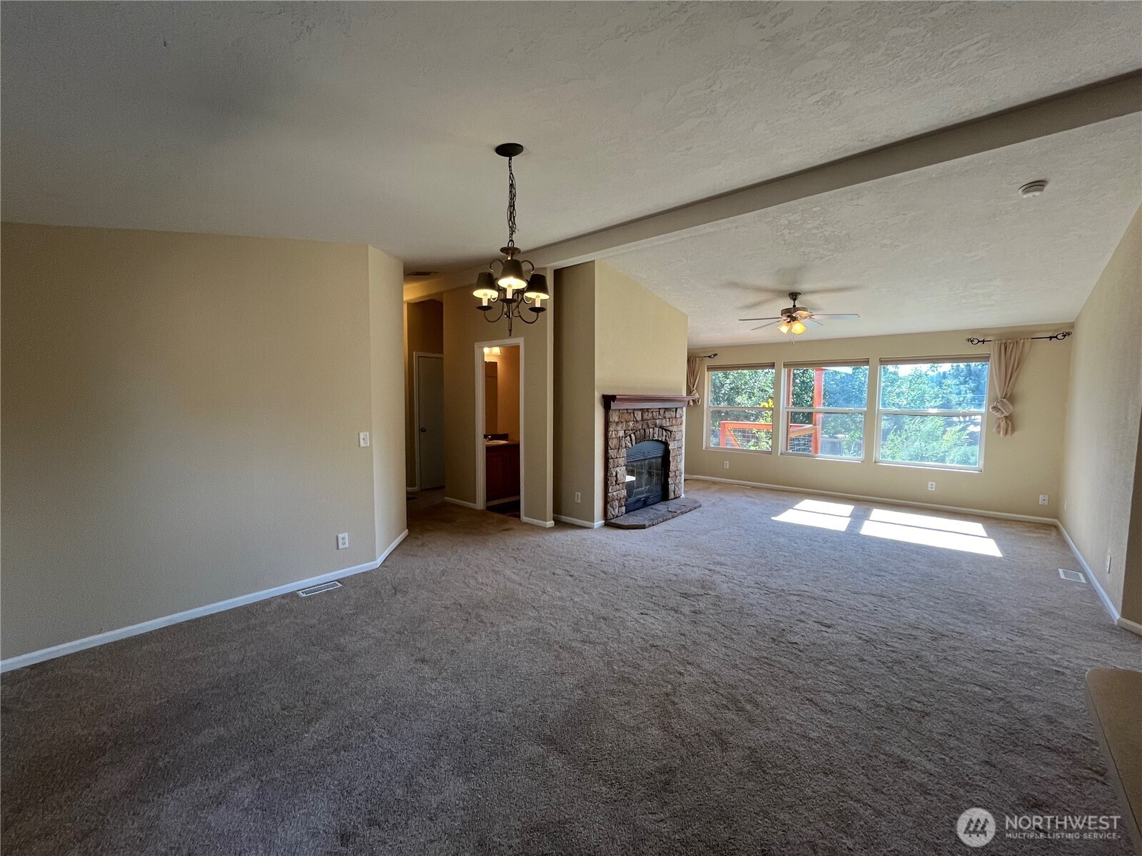 920 Castle Avenue Winthrop, WA 98862 - Photo 21 of 40 a view of empty room with floor to ceiling window and fireplace