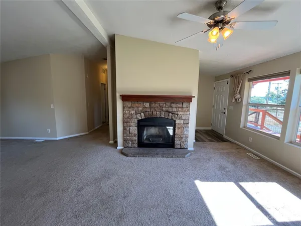 a kitchen with stainless steel appliances granite countertop a sink a stove cabinets counter space and wooden floor