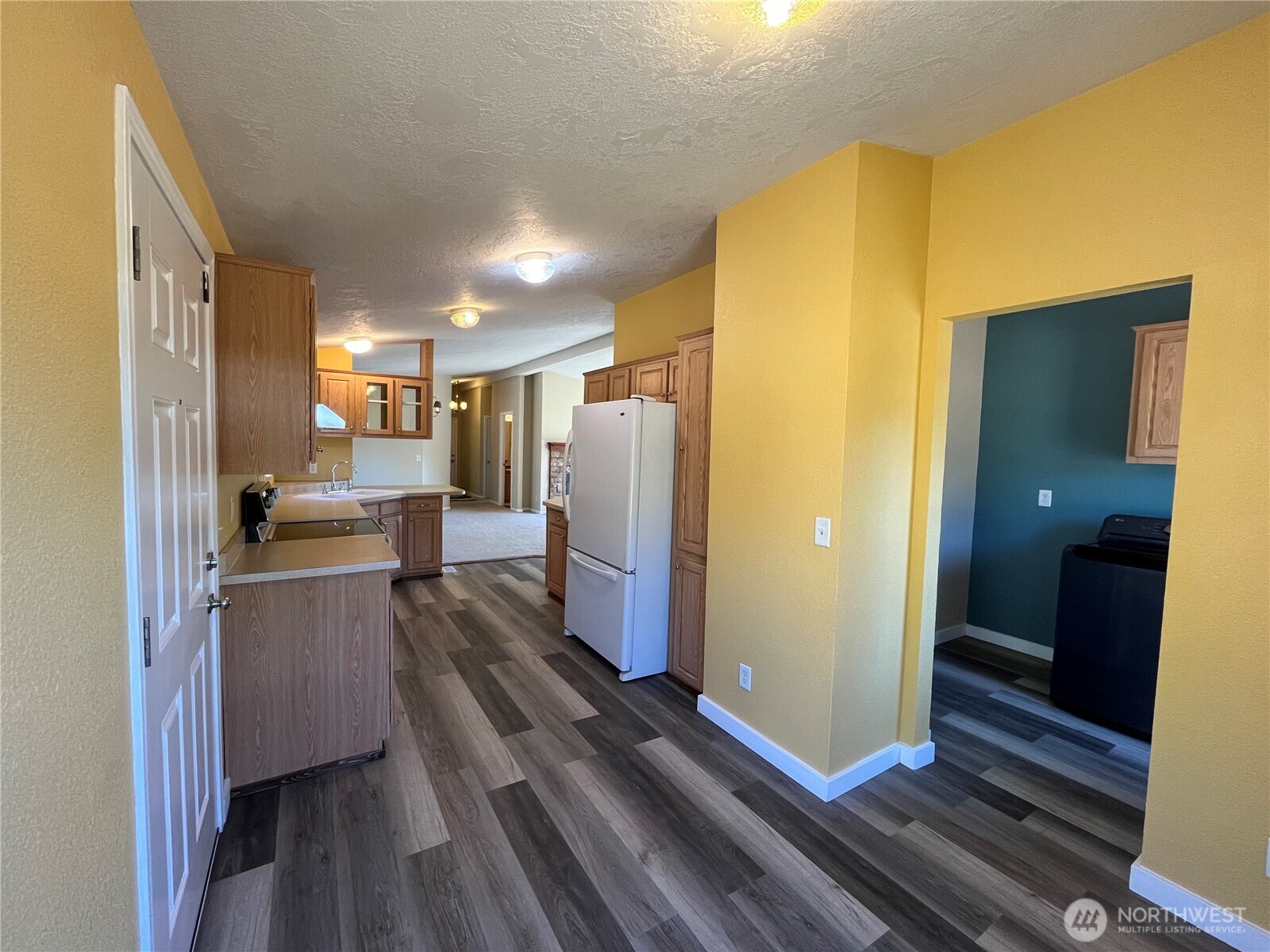 920 Castle Avenue Winthrop, WA 98862 - Photo 25 of 40 a kitchen with refrigerator and wooden floor