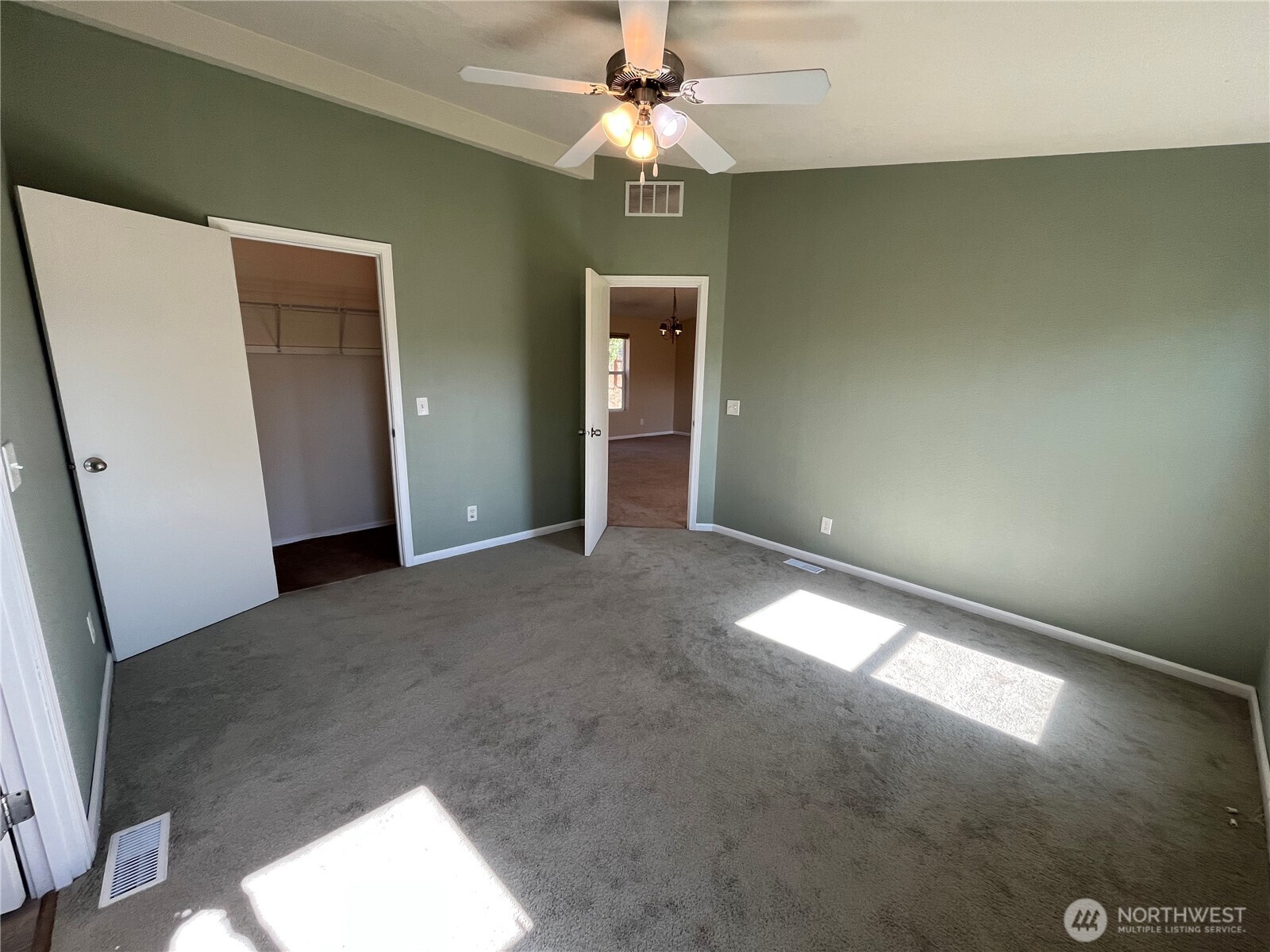 920 Castle Avenue Winthrop, WA 98862 - Photo 28 of 40 an empty room with a chandelier fan and windows