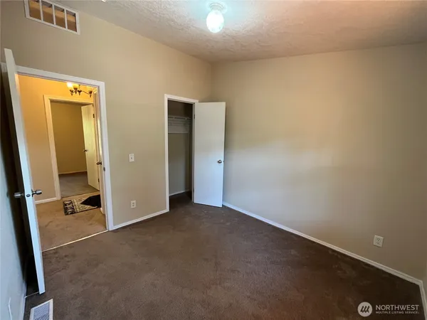 a view of an empty room with a hallway