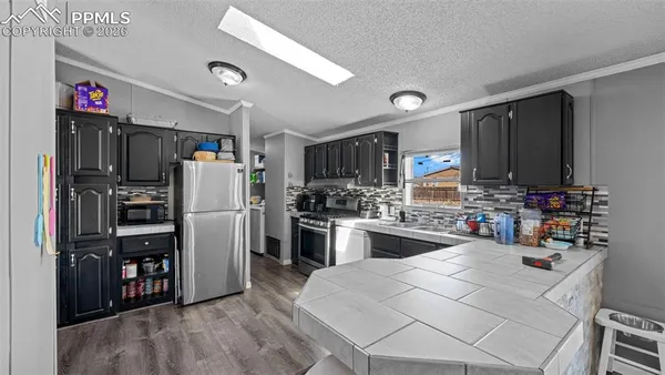 a kitchen with refrigerator and cabinets