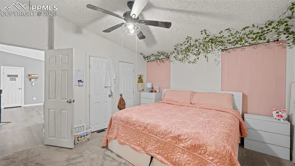 a bedroom with a large bed chandelier and a closet