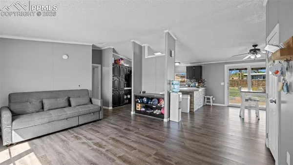 a living room with furniture and kitchen view