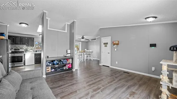 a living room with furniture and a wooden floor