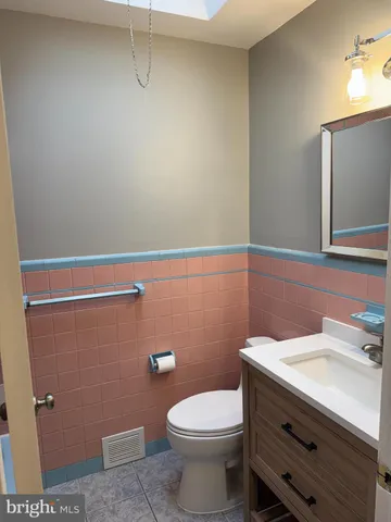 a bathroom with a sink a toilet and mirror