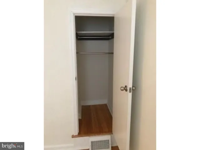 a bathroom with a walk in closet and mirror