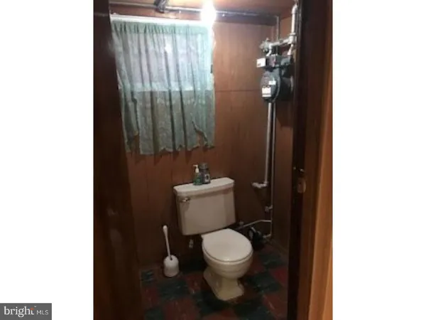 a white toilet sitting next to a bathroom sink