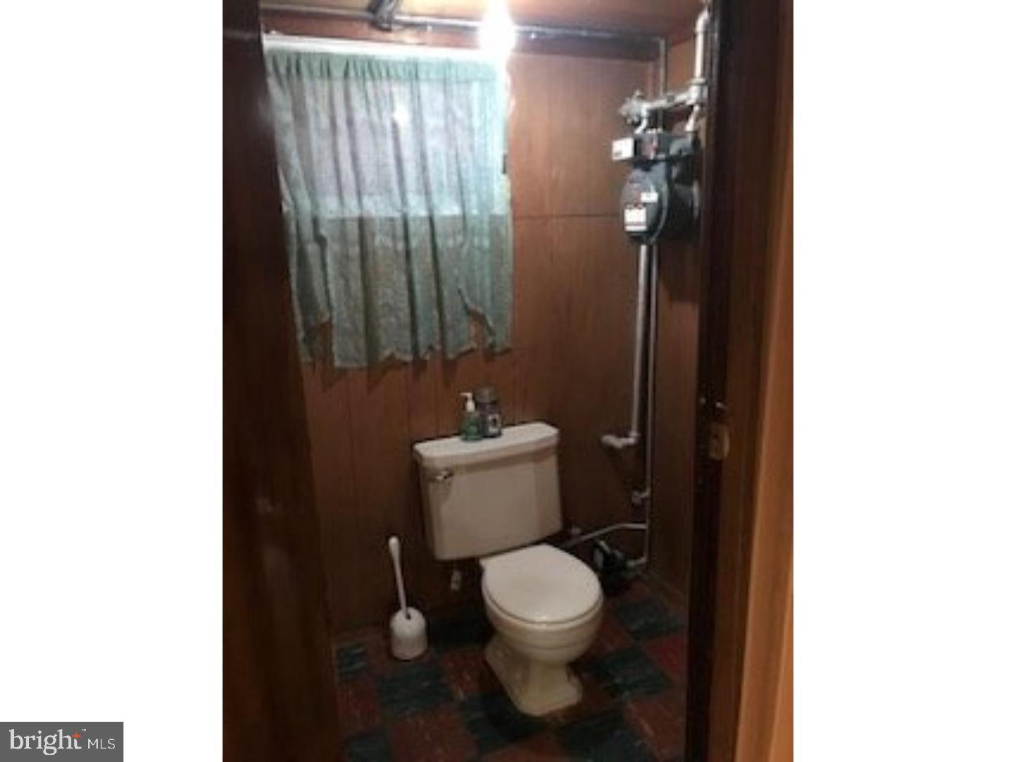 5149 Arbor Street Philadelphia, PA 19120 - Photo 19 of 23 a white toilet sitting next to a bathroom sink