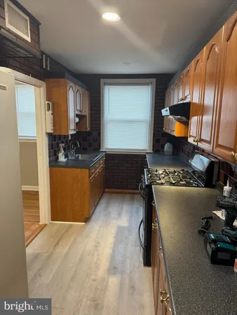 a kitchen with refrigerator and window