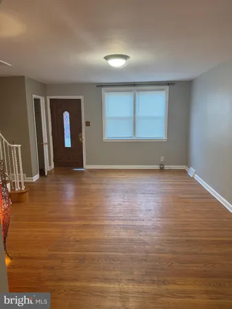 a view of room with window and wooden floor