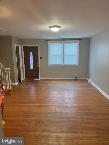 a view of room with window and wooden floor