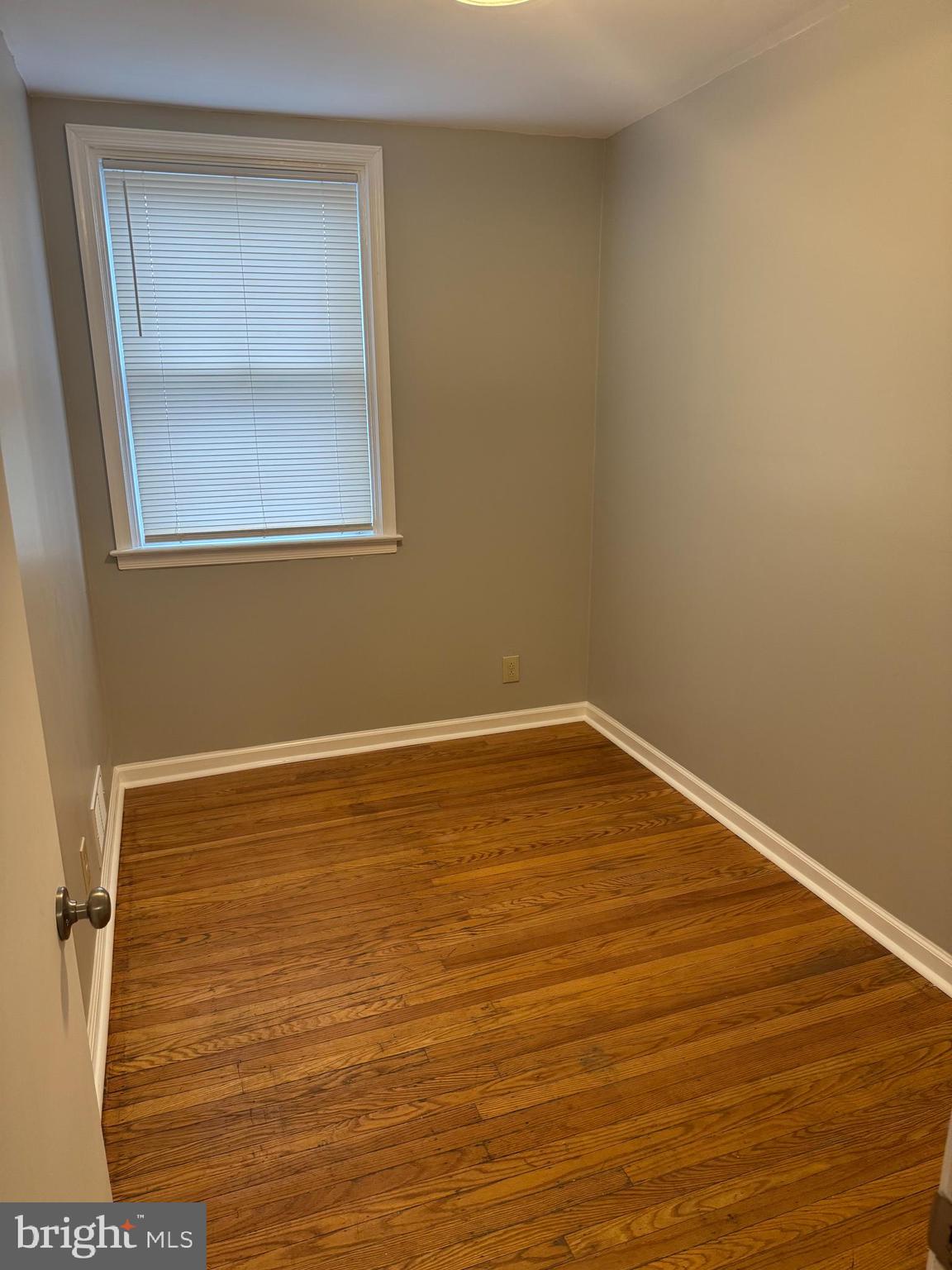 5149 Arbor Street Philadelphia, PA 19120 - Photo 8 of 23 a view of an empty room with wooden floor and a window