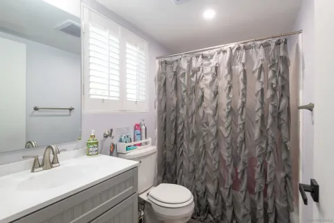 a front view of a house with plants