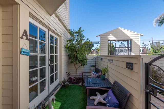 a view of a house with a yard and furniture