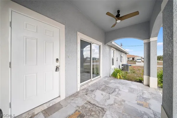 a view of a porch with a floor to ceiling window and a yard