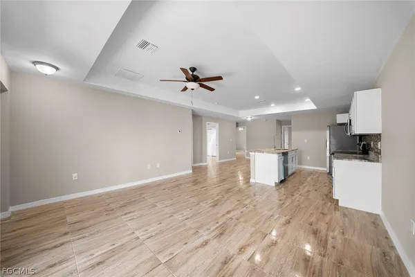 a view of a kitchen with a sink and refrigerator