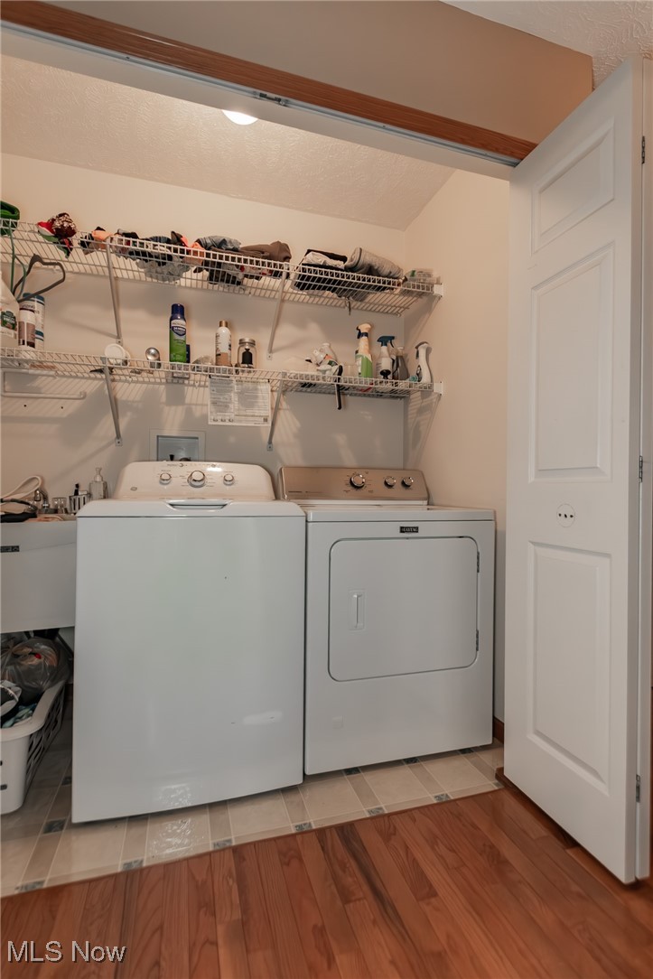 4815 South Ridge Road Perry, OH 44081 - Photo 30 of 48 Washroom featuring light wood-style flooring and washing machine and dryer