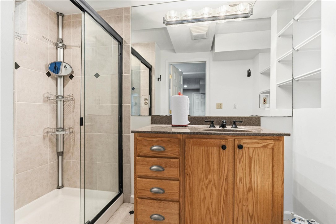 8781 Rupp Farm Drive West Chester, OH 45069 - Photo 39 of 48 This bathroom features a contemporary shower and a vanity with a large mirror.