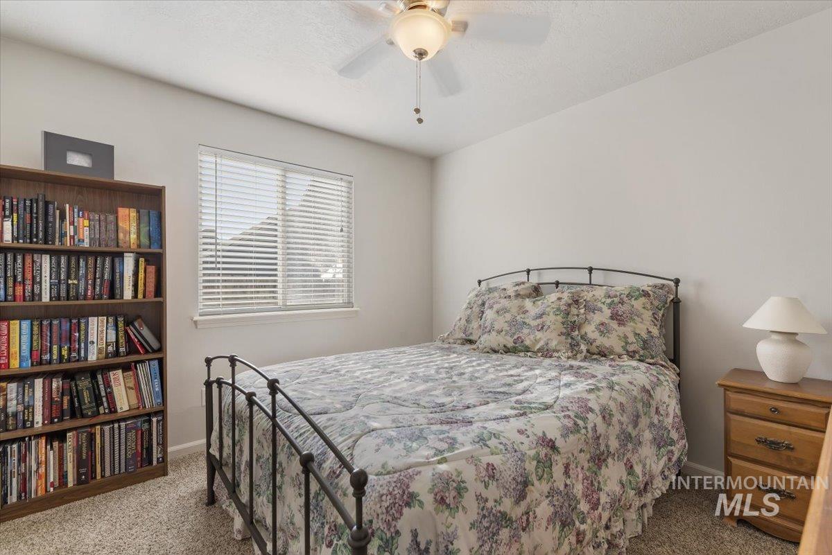 4167 North Arches Way Meridian, ID 83646 - Photo 18 of 36 Bedroom featuring ceiling fan and carpet