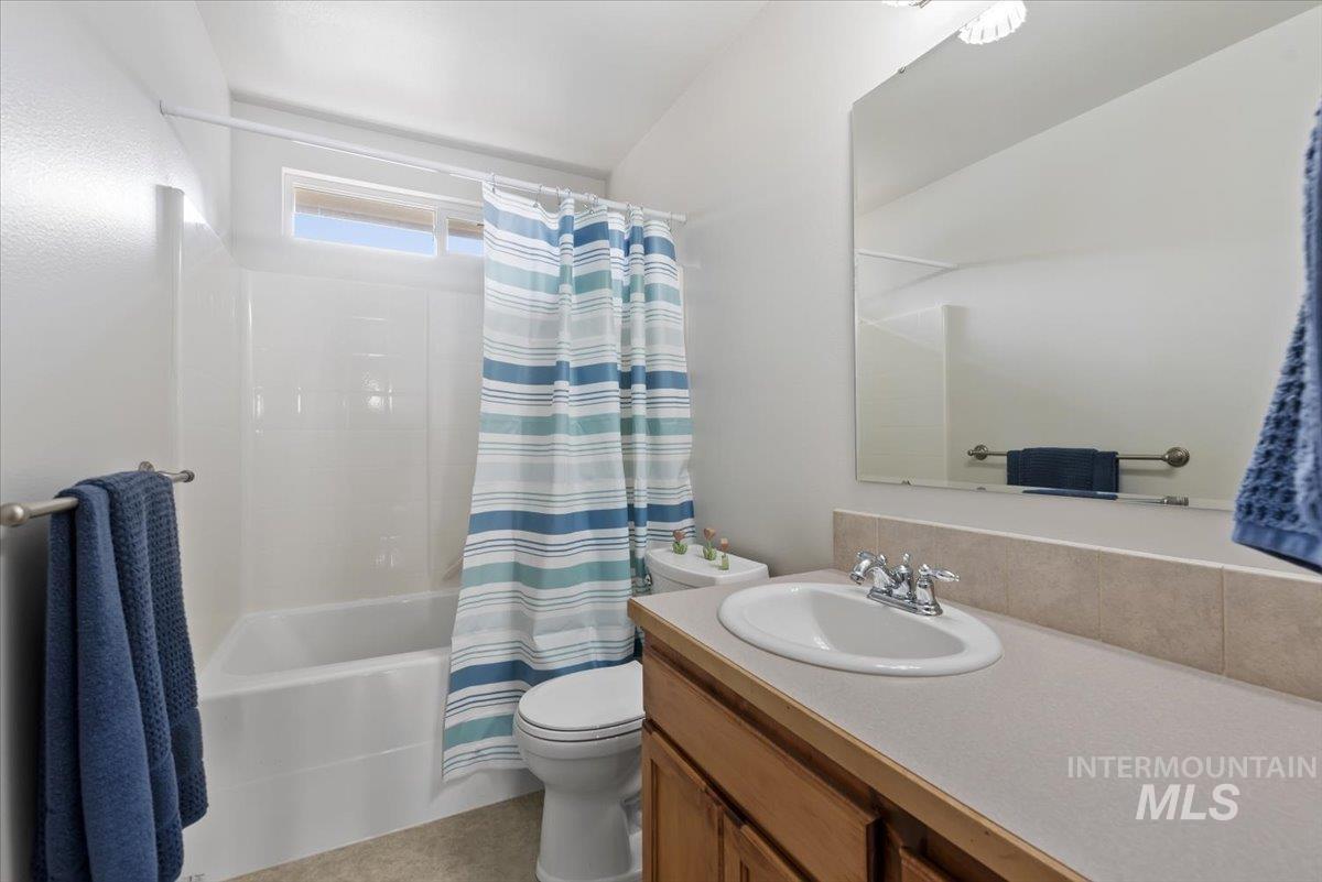 4167 North Arches Way Meridian, ID 83646 - Photo 19 of 36 Bathroom with vanity and shower / bathtub combination with curtain