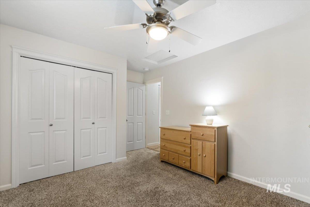 4167 North Arches Way Meridian, ID 83646 - Photo 22 of 36 Bedroom with light colored carpet, a closet, a ceiling fan, and attic access