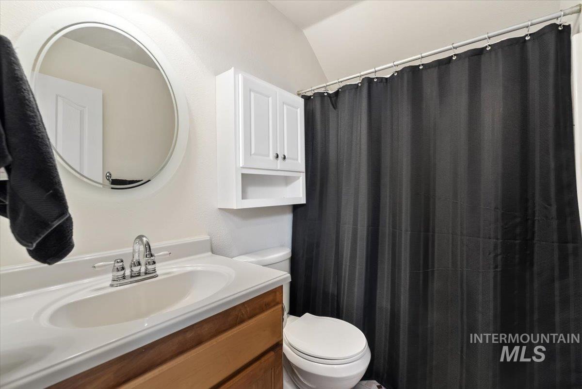 4167 North Arches Way Meridian, ID 83646 - Photo 27 of 36 Full bathroom with vanity, curtained shower, and lofted ceiling