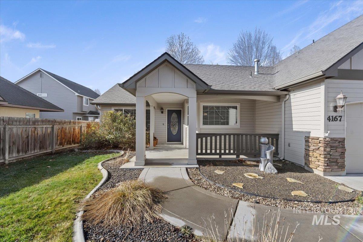 4167 North Arches Way Meridian, ID 83646 - Photo 4 of 36 View of front of property with a shingled roof, board and batten siding, a porch, stone siding, and an attached garage