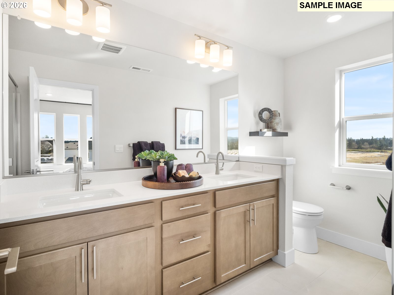 18218 Southwest Tippery Lane Beaverton, OR 97003 - Photo 17 of 21 a bathroom with a double vanity sink toilet and a mirror