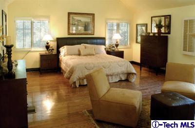 Undisclosed Address Pasadena, CA 91105 - Photo 5 of 16 a bedroom with a bed and wooden floor