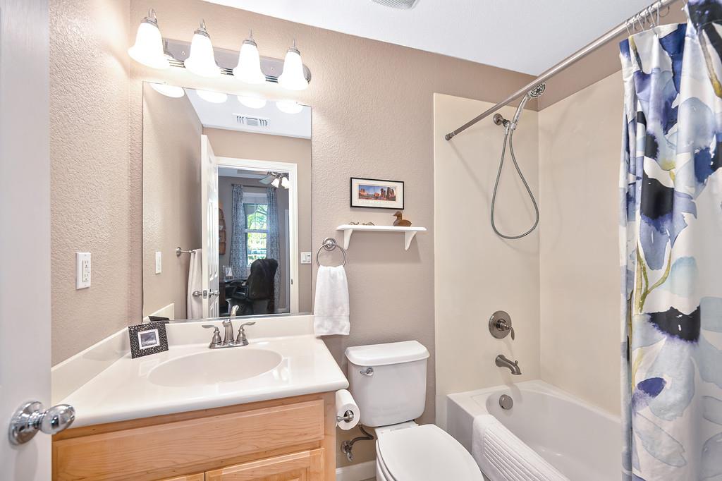 2603 Las Palomas Loop Lincoln, CA 95648 - Photo 17 of 28 a bathroom with a sink mirror toilet and shower