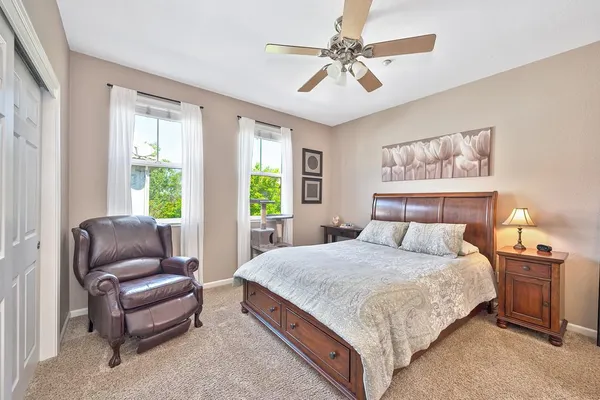 a bedroom with a large bed and a couch