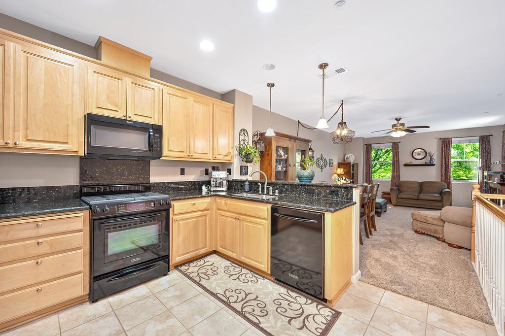 2603 Las Palomas Loop Lincoln, CA 95648 - Photo 22 of 28 a kitchen with stainless steel appliances granite countertop a stove a sink and a microwave