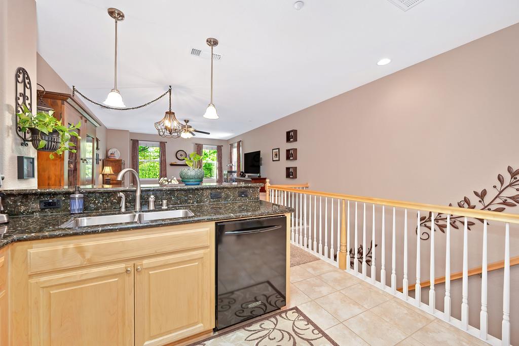 2603 Las Palomas Loop Lincoln, CA 95648 - Photo 23 of 28 a kitchen with kitchen island granite countertop a sink a counter top space and cabinets