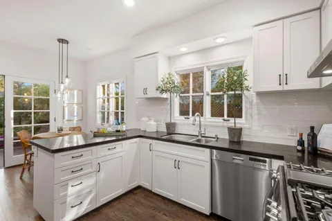 a kitchen with a sink stove and cabinets