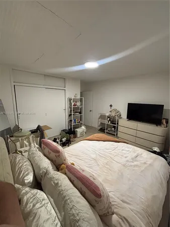 a bedroom with a bed and a chair