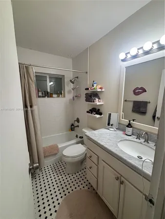 a bathroom with a sink toilet a mirror and vanity
