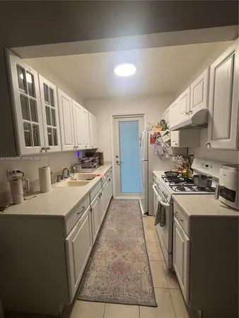 a kitchen with stainless steel appliances granite countertop a sink stove oven and refrigerator