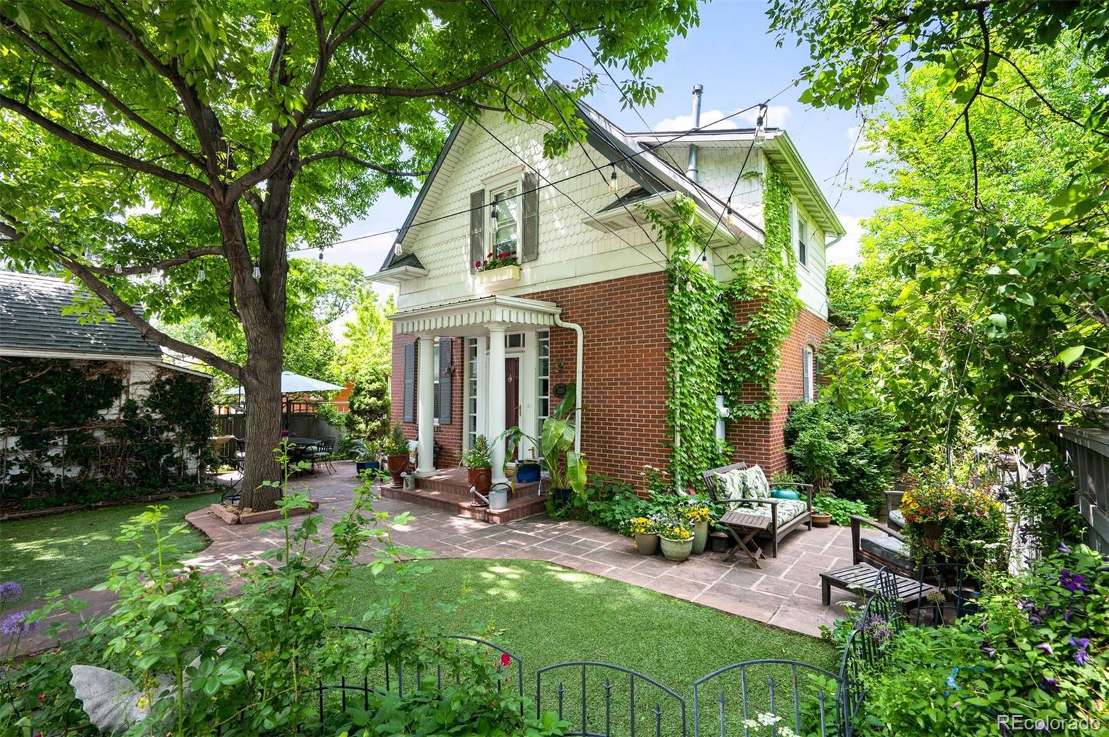 1324 South University Boulevard Denver, CO 80210 - Photo 2 of 47 a view of a house with backyard sitting area and garden